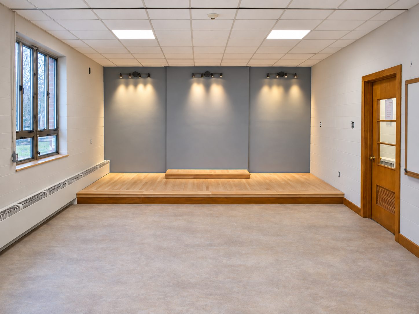 Stage flooring and wall lighting in place while painting and window preparation continue
