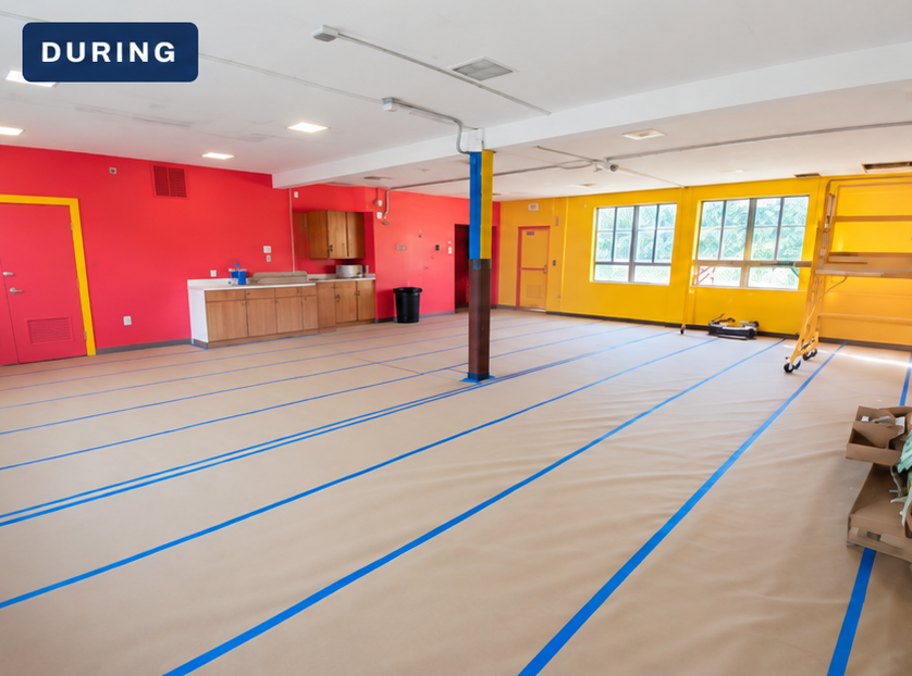 Daycare classroom prepared with floor protection and ceiling panels still in place