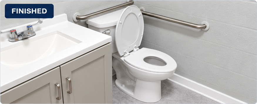 Finished daycare restroom showing the vanity, toilet, grab bars, gray flooring and white baseboard