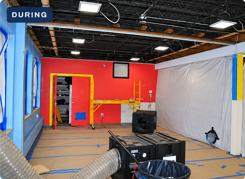 Open ceiling structure above a protected daycare work area with equipment and ducting