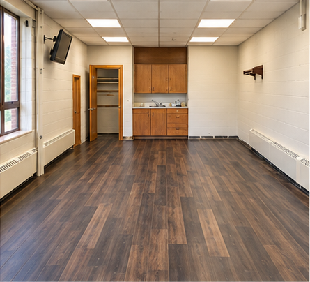 Later-progress room presentation showing brown wood-look flooring, wood cabinetry, a sink and light walls